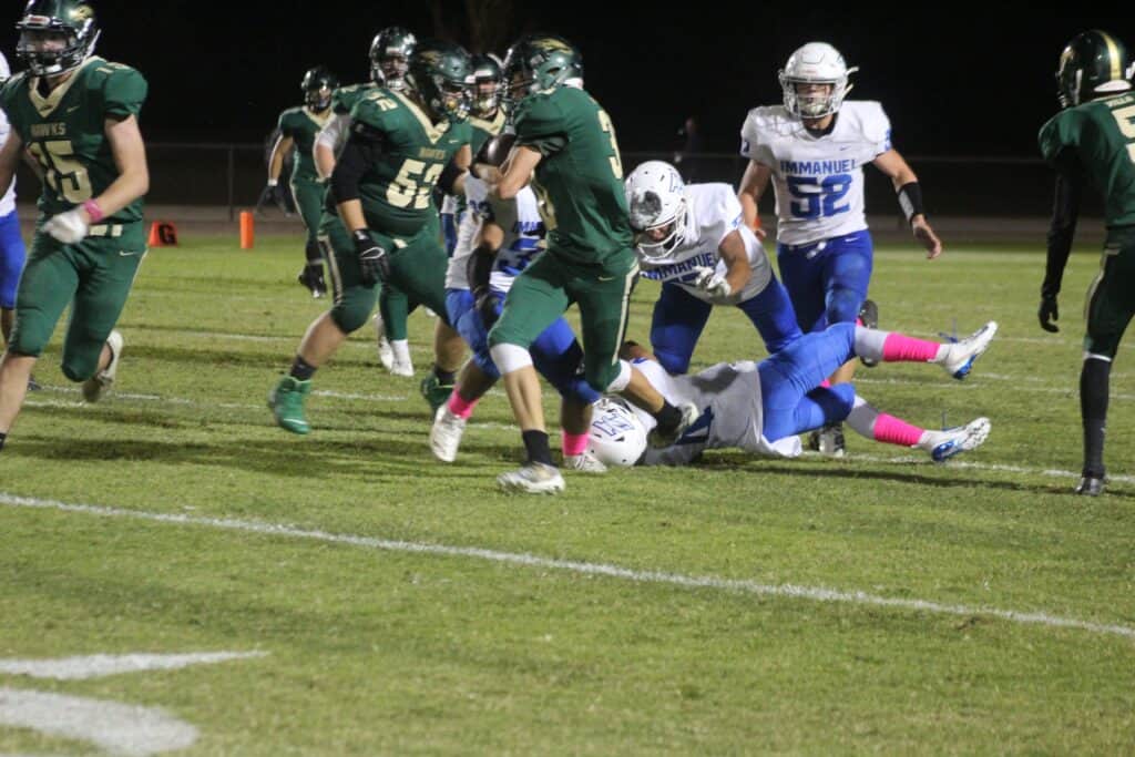 Photo - Liberty’s Steven Protzman runs out of an Immanuel tackle during Friday’s loss to the Eagles. Protzman scored one of two touchdowns for the Hawks.