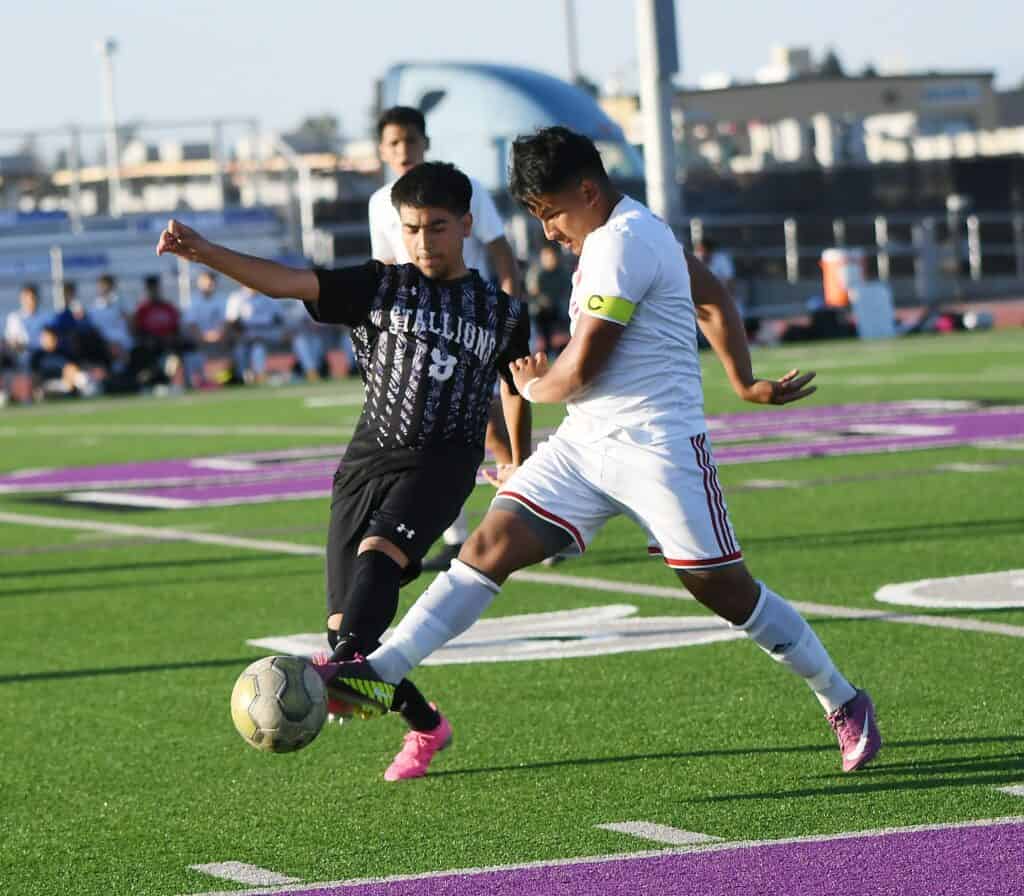 Photo - Madera South senior Luis Diaz battles with a Sanger defender during Wednesday’s loss to the eventual league champions.
