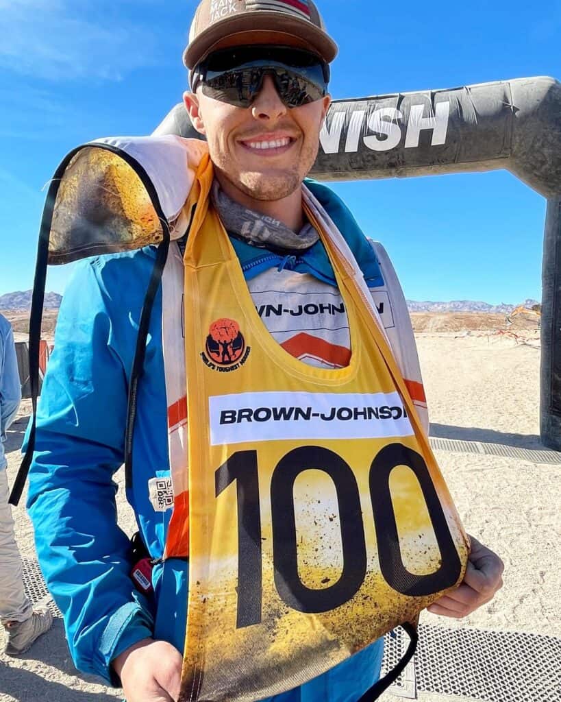 Madera High School graduate Christian Brown-Johnson proudly shows off his 100-mile bib after running 100 miles in 24 hours at last month’s World’s Toughest Mudder event in Laughlin. He is the ninth person in the world to reach that milestone. Photo - Courtesy of Kelsee Montagna