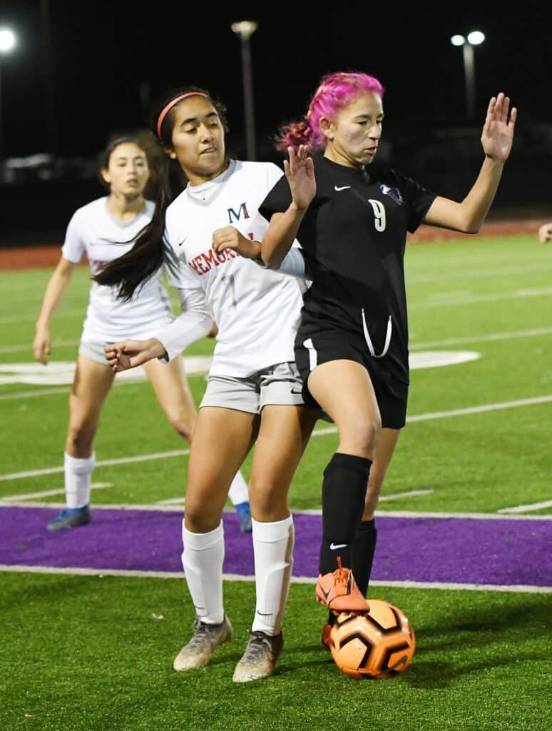 Photo - Madera South’s Noemi Alfaro controls the ball away from a San Joaquin Memorial Panthers’ defender during Wednesday’s match. Alfaro scored the second of Madera South’s two goals in a 4-2 loss.