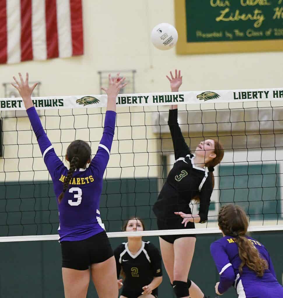 Photo - Liberty’s Lucia Somilleda reaches up for one of her team-high six kills in a three-set loss Tuesday to the Minarets Mustangs.