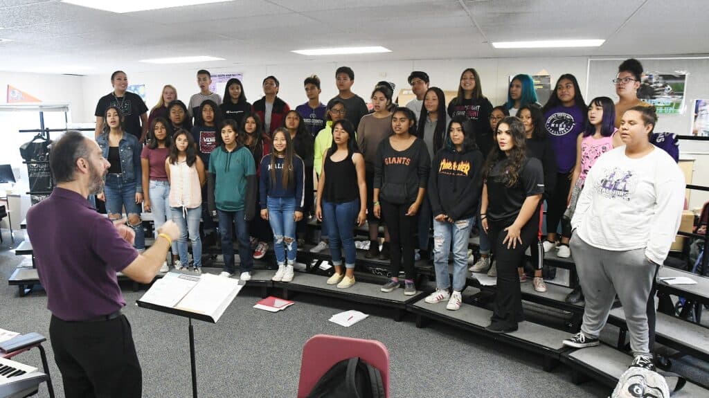 Photo - Madera South High School choir director Roger Harabedian leads the choir in practice.