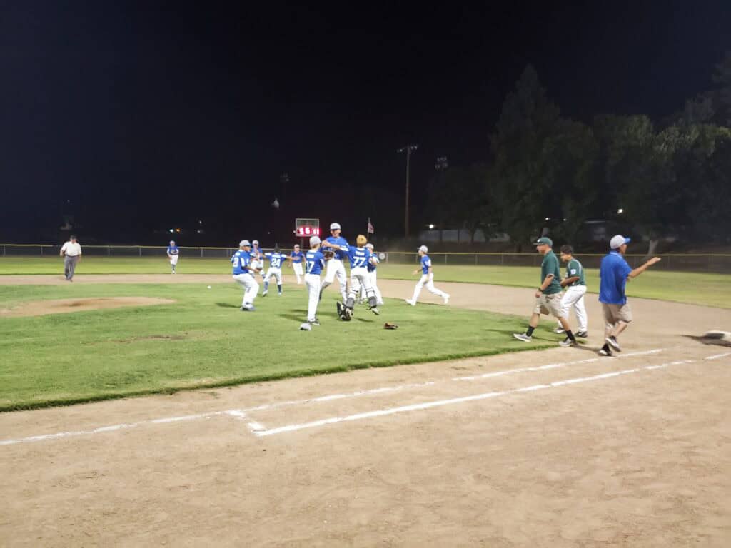 Photo - The Madera National Little League 10-12-year-old All-Stars celebrate after the final out was made to win the District 10 championship for the first time since 2011.
