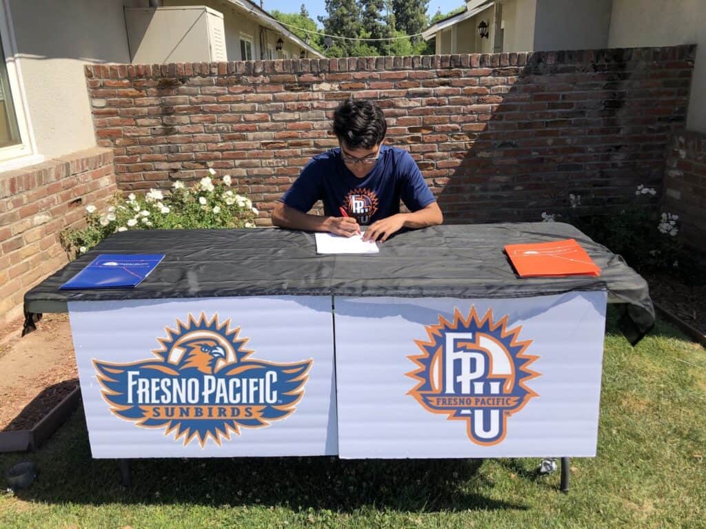 Photo - Madera South’s Luis Ortega signs a National Letter of Intent to run cross country at track next season at Fresno Pacific University.