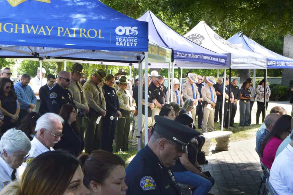 Photo - Peace officers from various departments gather at Courthouse Park Tuesday morning for a memorial ceremony for fallen officers.