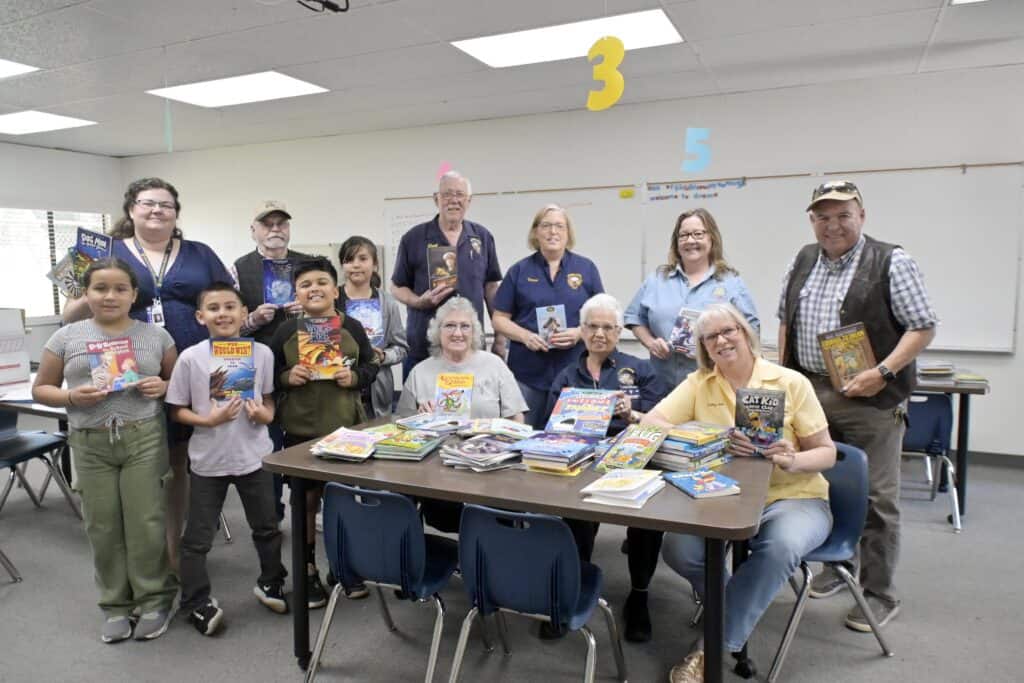 Photo - Madera Elks Club members gather with students from Eastin Arcola School in the reading room with books the Elks donated for their “Adopt a School” program.