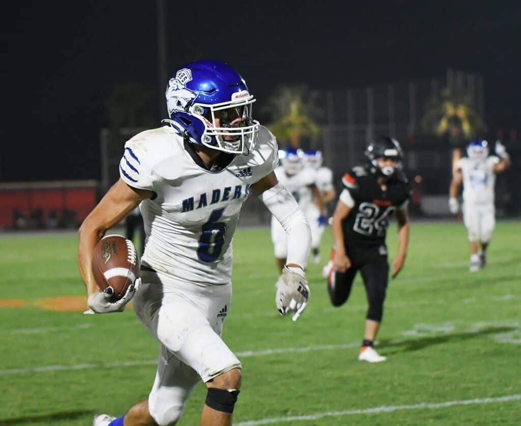 Photo - Madera’s Logan Wattenbarger looks for more yardage during Friday’s victory over Selma. He scored two touchdowns in the 35-0 win.