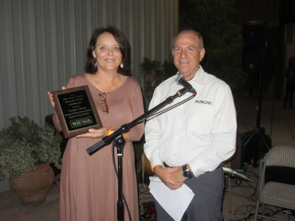 Photo - Cynthia Wood of the viticulture and enology program at California State University Fresno receives the MVA Honorable Partner award from Demetrio Papagni owner of Papagni Wines.