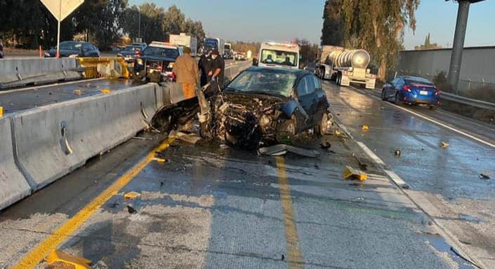 Photo - A wrecked car sits facing the wrong direction on southbound SR 99 after the driver failed to stop for slowing traffic on Tuesday morning. A multiple vehicle collision briefly closed both sides of the north and southbound lanes and snarled traffic all the way from Madera Avenue to Avenue 12.