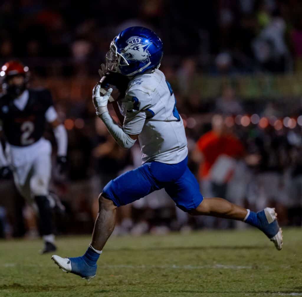 Photo - Madera’s Lawrence Flores hauls in a pass during Friday’s loss to Merced. Flores caught six passes for 93 yards with a touchdown.