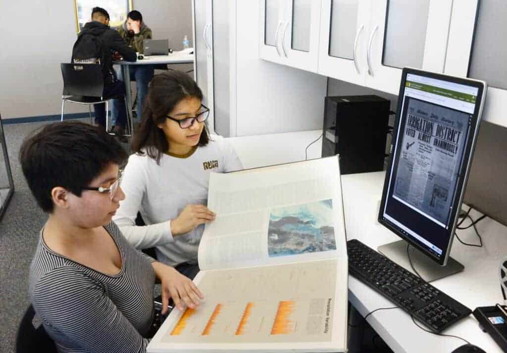 Photo - Madera South High graduates and current UC Irvine students Silvia Navarro Hernandez, left, and Jennifer Martinez are doing research for a water story at Madera South High during their spring break.