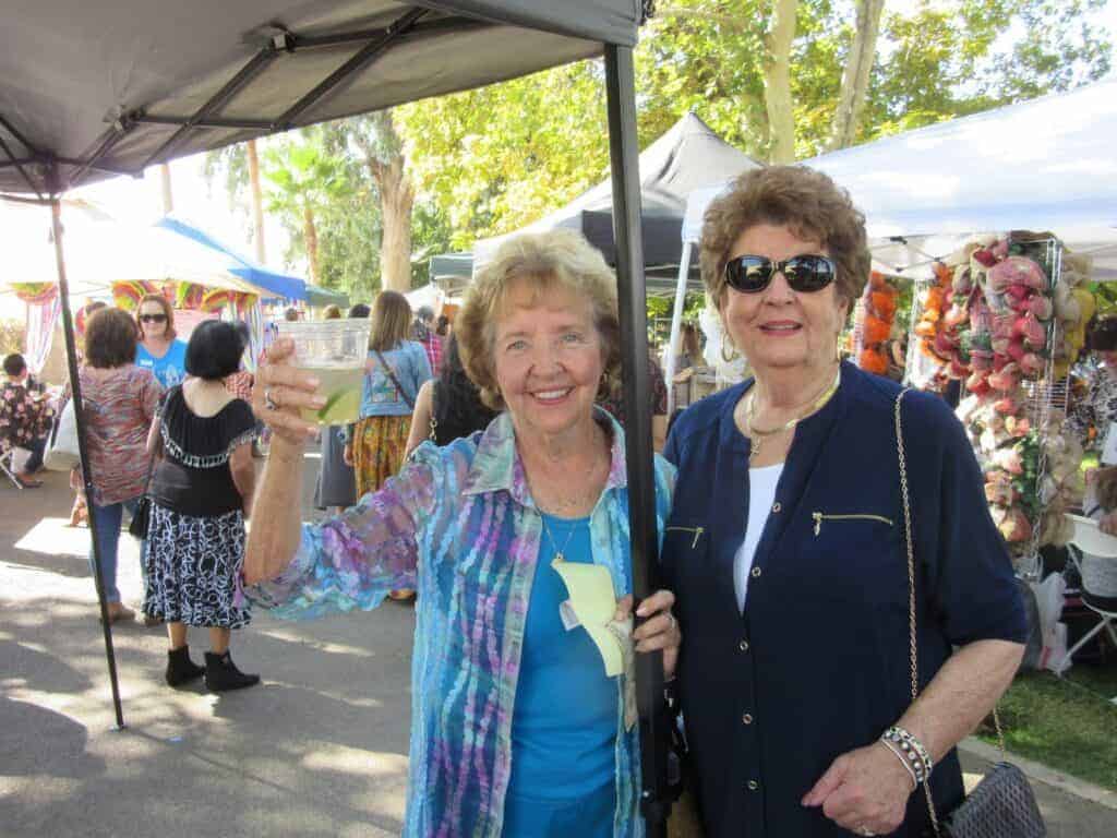 Photo - Long-time friends Ila Schoettler, left, and Chris Nawrocki laughingly pretend to pole dancers at the Alegria Guild Day in the Country.