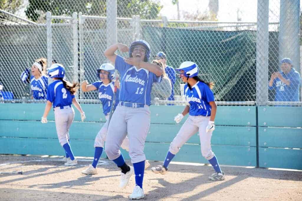 Photo - Madera’s Sofia Perez reacts after scoring on Neveah Montes’ single to give the Coyotes the early lead in a 5-3 loss Thursday to Clovis North.