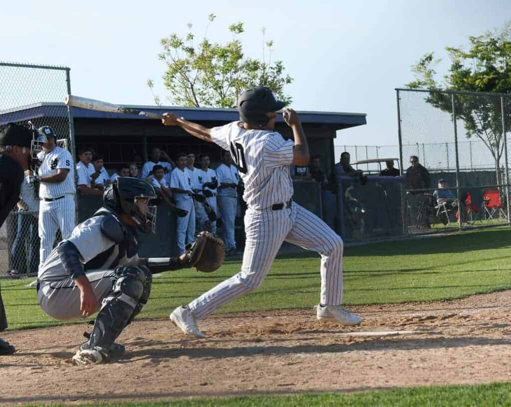 Photo - Madera South’s Caleb Bertoncini hits a single up the middle to drive in the tying run Friday before the Stallions lost in extra innings to Bullard.