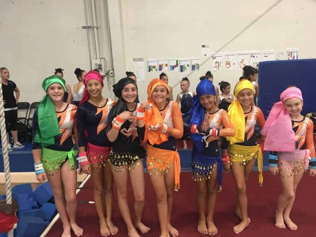 Photo - TEC Gymnastics Leve 4 gymnasts stand with their gypsy outfits at the Gypsy Invitational in Concord.