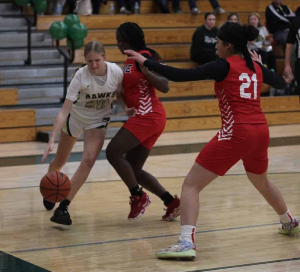 Photo - Liberty’s Macie Webster tries to drive by a Chowchilla defender during Friday’s loss. Webster led the Hawks with six points and pulled down six rebounds. 