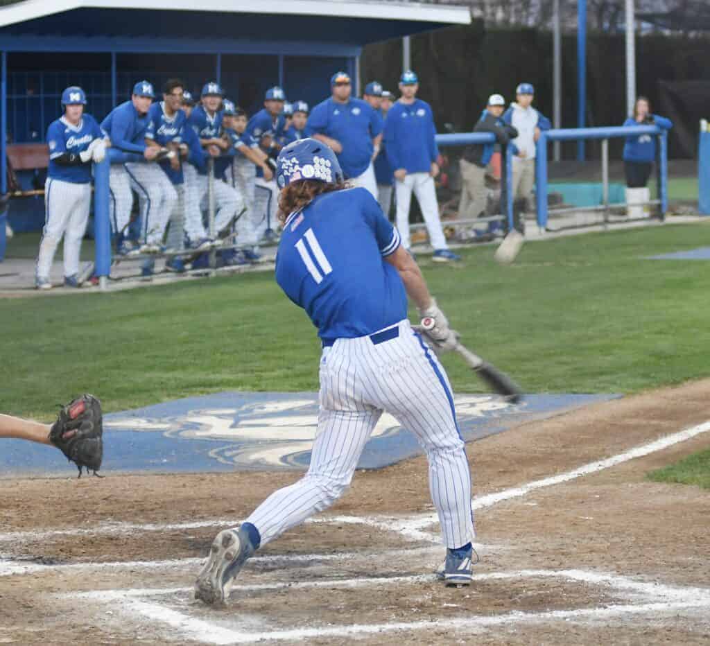 Photo - Madera’s Brian Hefner clears the bases with a three-run home run in a 6-5 victory over Consumnes Oaks on Tuesday. He had a hit in each game in the Fresno Easter Classic while driving in seven runs and pitched Madera to a victory Wednesday.