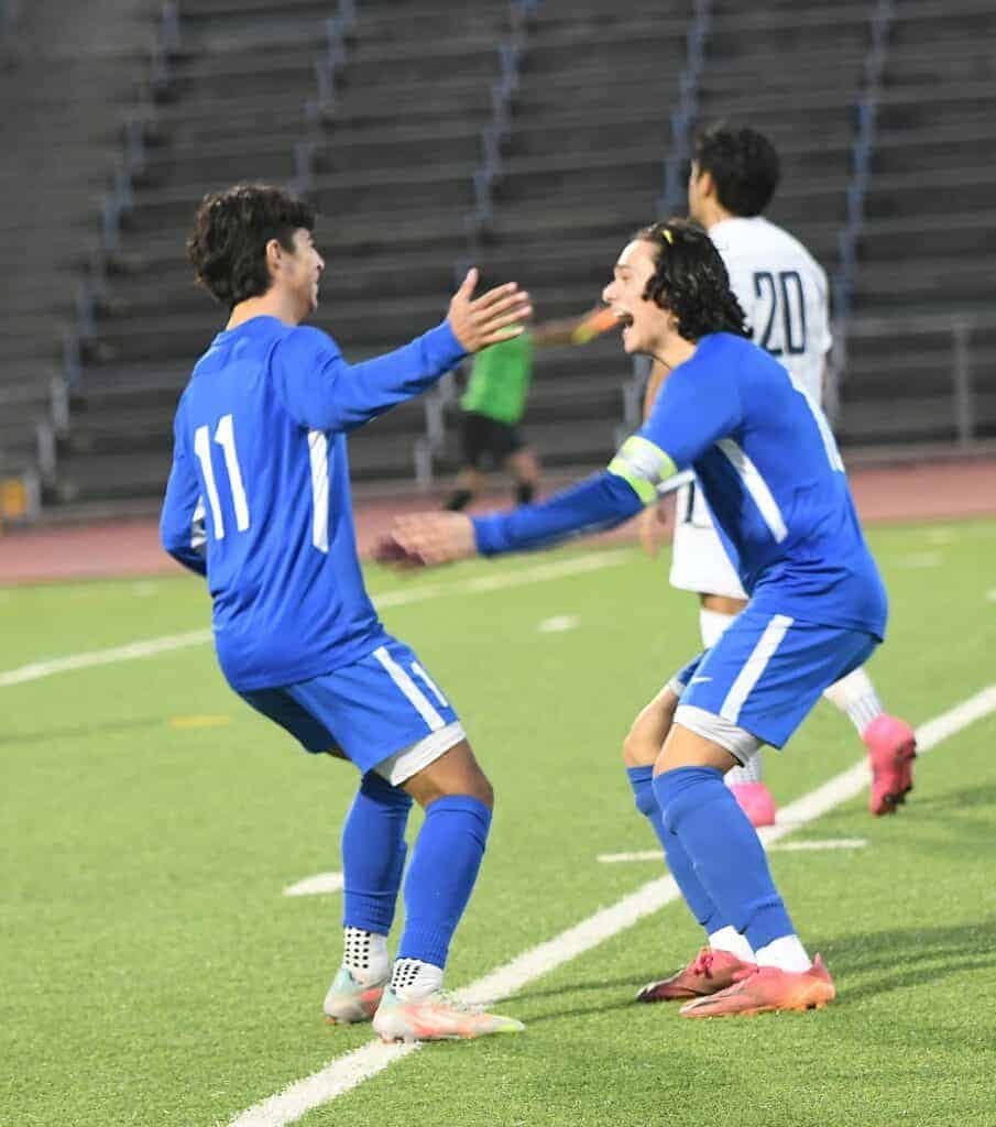 Photo - Elias Zuniga, right, congratulates Dylan Castro (11) after he scored a goal Wednesday night. Zuniga also scored a goal in a 5-3 victory over San Joaquin Memorial.