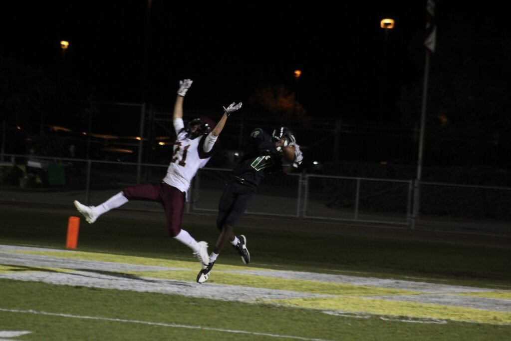 Photo - Liberty’s Charlie Smith hauls in a touchdown pass over the arms of Sierra’s Christian Rue for the first of nine Hawks’ scores Friday night.