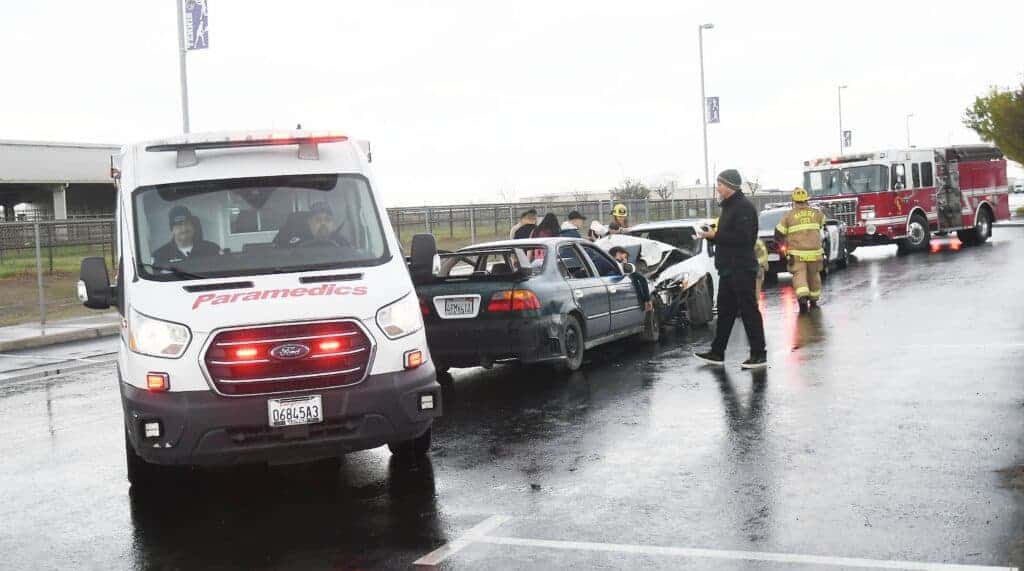 Photo - Madera South High students look on as first responders are on scene at a staged DUI fatality traffic accident on campus Thursday morning for the first half of the Every 15 Minutes program.