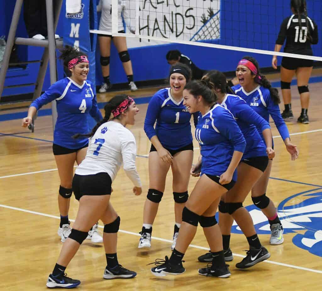 Photo - The Madera Coyotes girls volleyball team celebrates a point during its four-set victory over Madera South on Thursday in Joe Flores Gym.