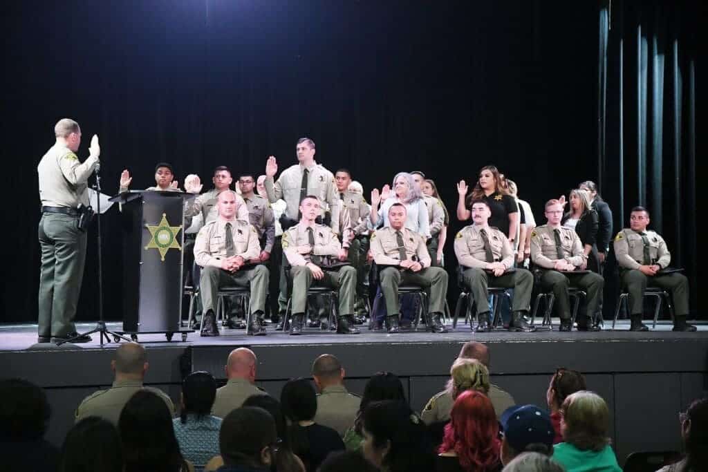 Photo - Madera County Sheriff Tyson Pogue swears in new hires and those promoting during a Swearing-In, Promotions and Awards Ceremony at Madera South High School on June 29.