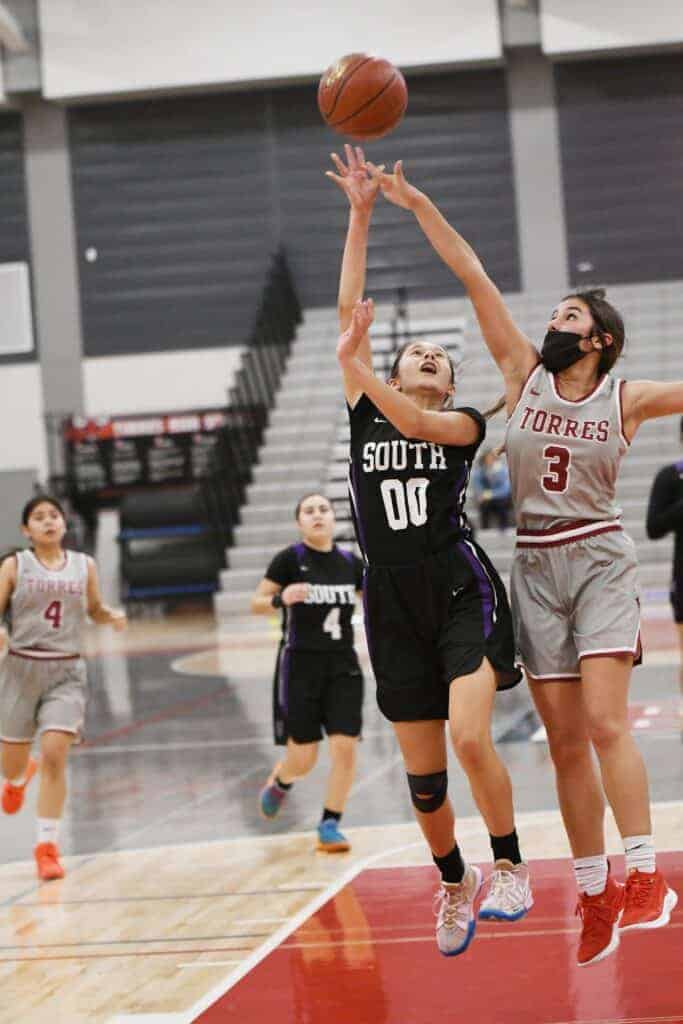 Photo - Madera South’s Brianna Lorta drives for a layup over the outstretched arms of Torres’ Sabrina Cerrillo.