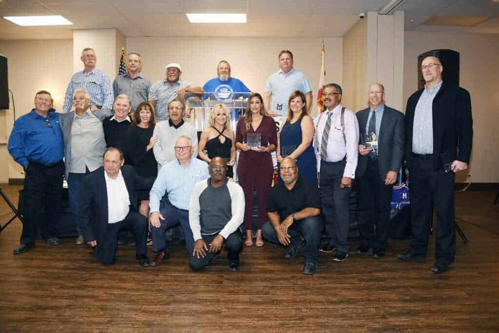 Photo - Madera Athletic Hall of Fame inductees gather for a group photo during the induction ceremony Saturday at the Peter’s Brothers Banquet Hall. This is the seventh class of inductees into the Hall of Fame.