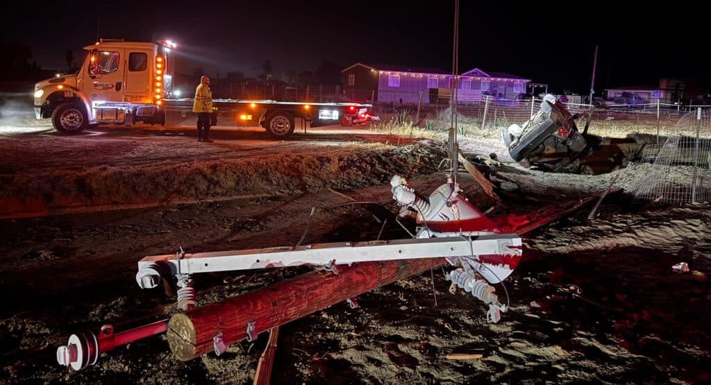 Photo - A Nissan Altima sits on its side after the driver lost control, and hit a telephone pole Sunday evening. The crash claimed the life of the passenger in the vehicle.