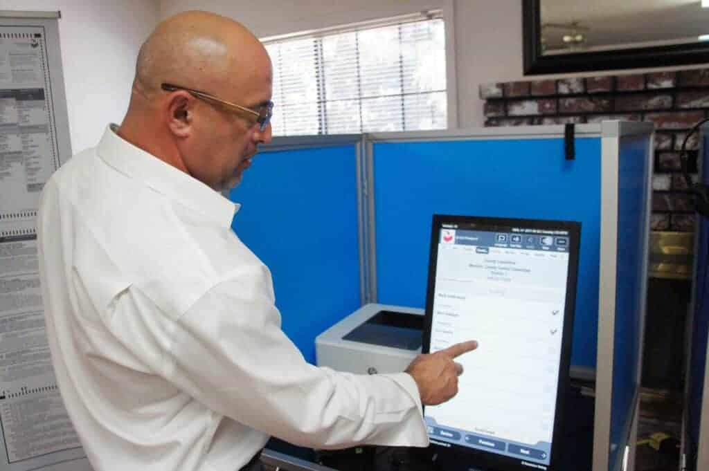 Photo - Steven Bennett, Regional Sales Manager at Dominion Voting Systems, gives a demonstration.