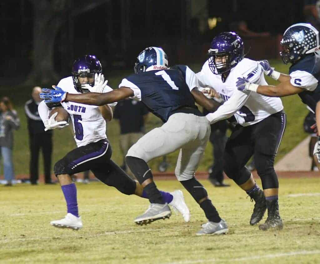 Photo - Madera South’s Mathew Posas tries to break away from a Bullard defender during Thursday’s loss.