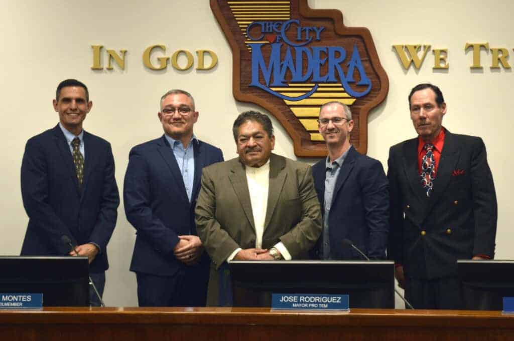 Photo - Juan Montemayor, center, was honored by members of the Madera City Council after he announced his plans to retire this year. Behind him, from left, are Mayor Pro Tem Jose Rodriguez, councilmen Steve Montes, Rohi Zacharia and Artemio Villegas.