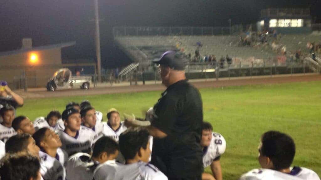 Photo - Madera South head coach Dane Cook talks to his team after they won their first game of the season and also gave him his first varsity head coaching victory in 2014.