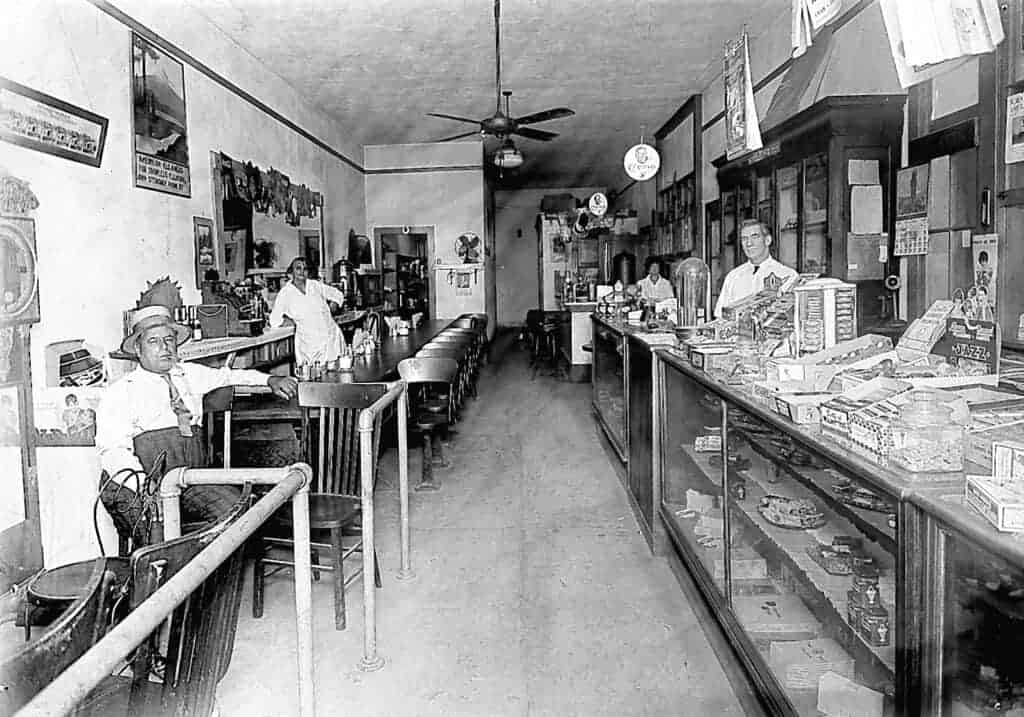 Photo - Ray Northern looks much more peaceful here standing behind the counter on the right than he must have as a town marshal in a shootout at the Club saloon.
