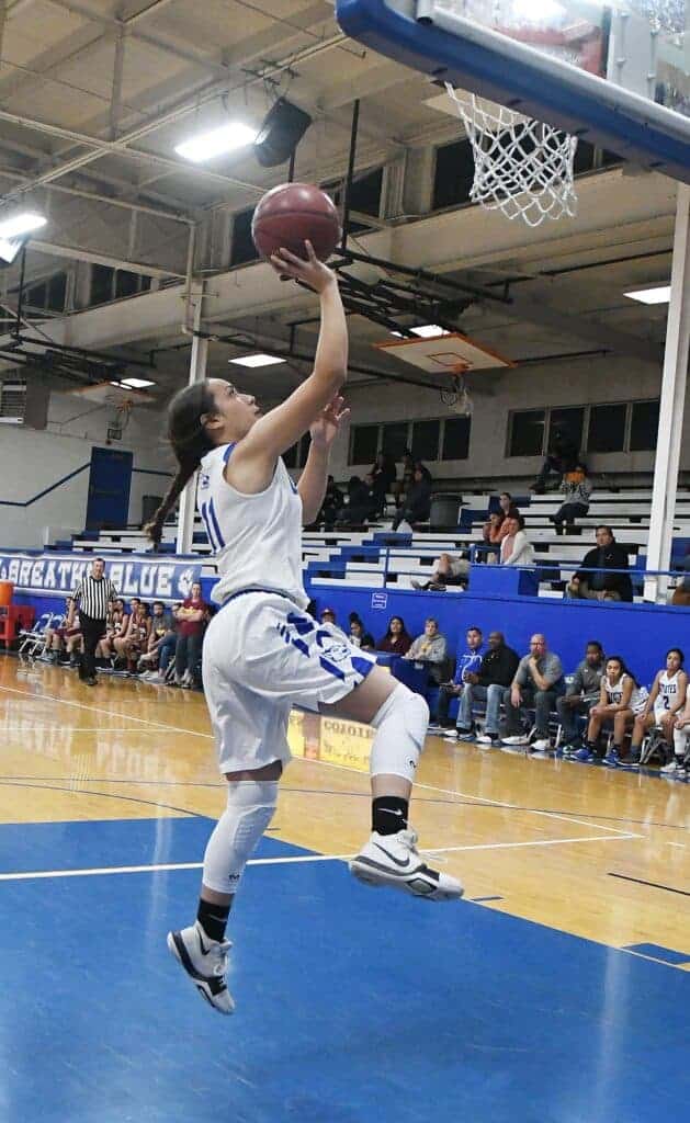 Photo - Madera’s Cathy Figueroa drives for a layup during the season opener Tuesday. She scored a team-high 16 points in a 55-40 loss to Sierra.