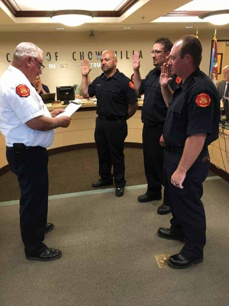 Photo - Chowchilla Fire Chief Harry Turner swears in three new volunteer firefighters during the city council meeting on Tuesday. They are Casey House, Pete Ramos and Justin R. White.