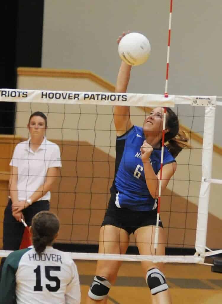Photo - Fomer Madera Coyotes girls volleyball standout Kelsee Montagna rises up for a kill attempt during a 2011 match against Hoover-Fresno.