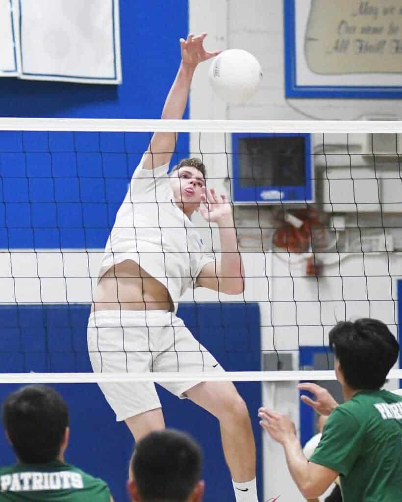 Photo - Madera middle blocker Hunter Brown puts down one of his six kills in a three-set sweep over Hoover on Tuesday.