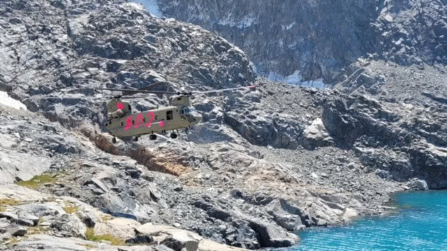 Photo - A CH-47 Chinook helicopter flies over parts of the Sierra-Nevada Mountains to rescue an injured hiker and the search party last week.