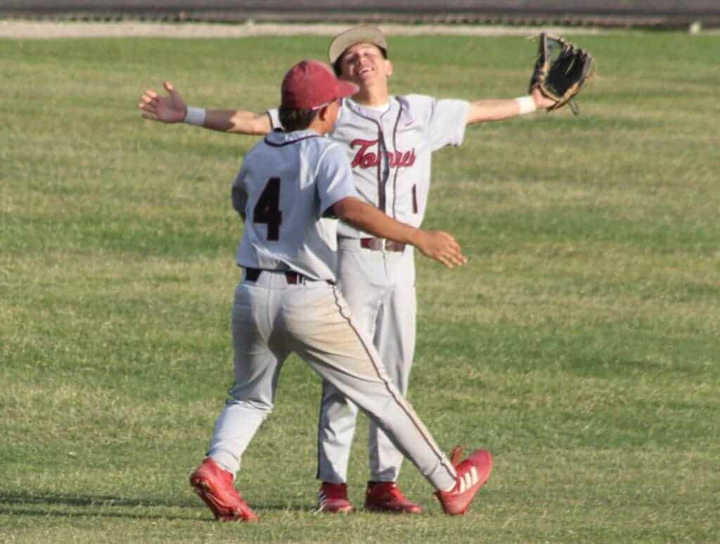 Photo - Torres centerfielder Trey Garcia is met in centerfield by his brother, Dominic, to celebrate the final out of Friday’s semifinal game to send the Toros to the Div. VI championship game.