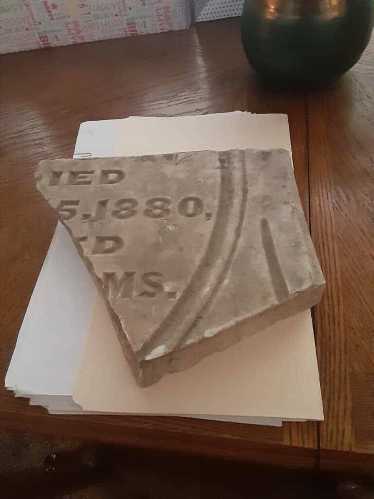 Photo - Shown here is a piece that was clearly once part of Gabriel Bibbard Moore's tombstone. Dixieland students plan to restore it to its rightful place.