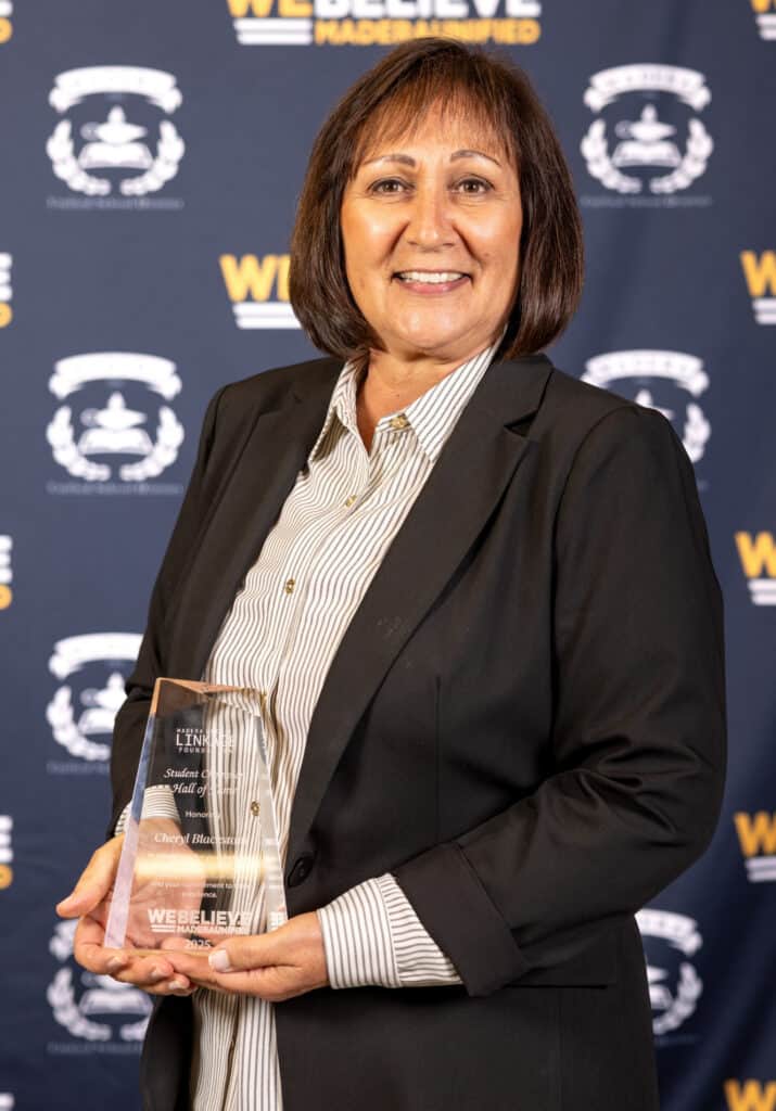 Photo of Madera Linkage Foundation Student Hall of Fame inductee Cheryl Blackstone holds her award after being honored at the annual MUSD Service with Pride event.