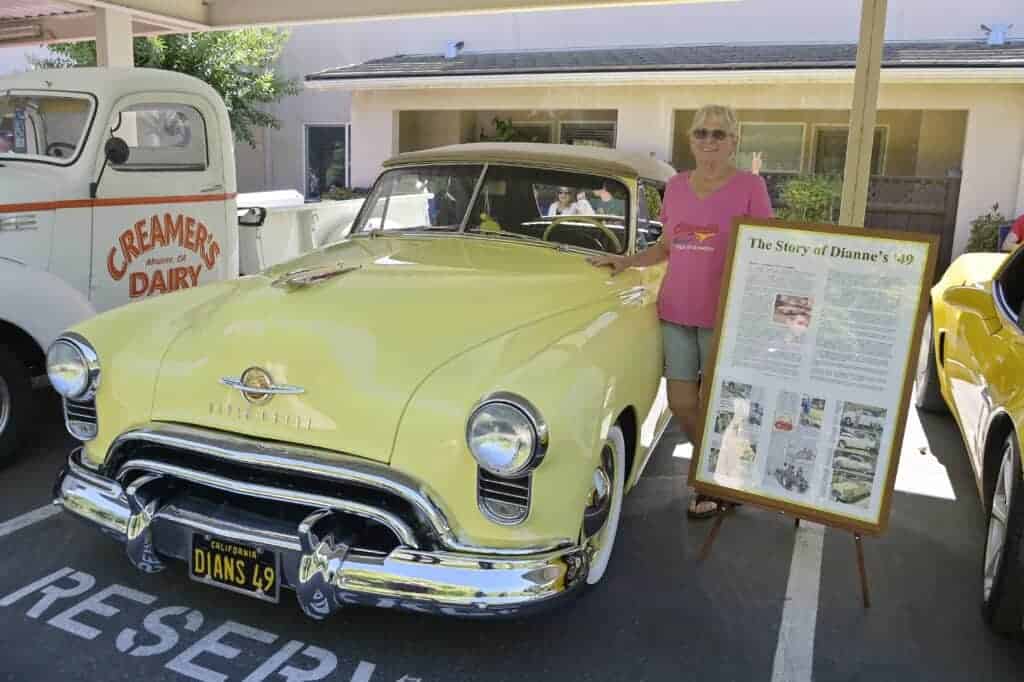 Photo - Dianne McGuire shows off her 1949 Oldsmobile convertible at Cogir’s Cedar Creek’s Father’s Day Car Show on Friday.