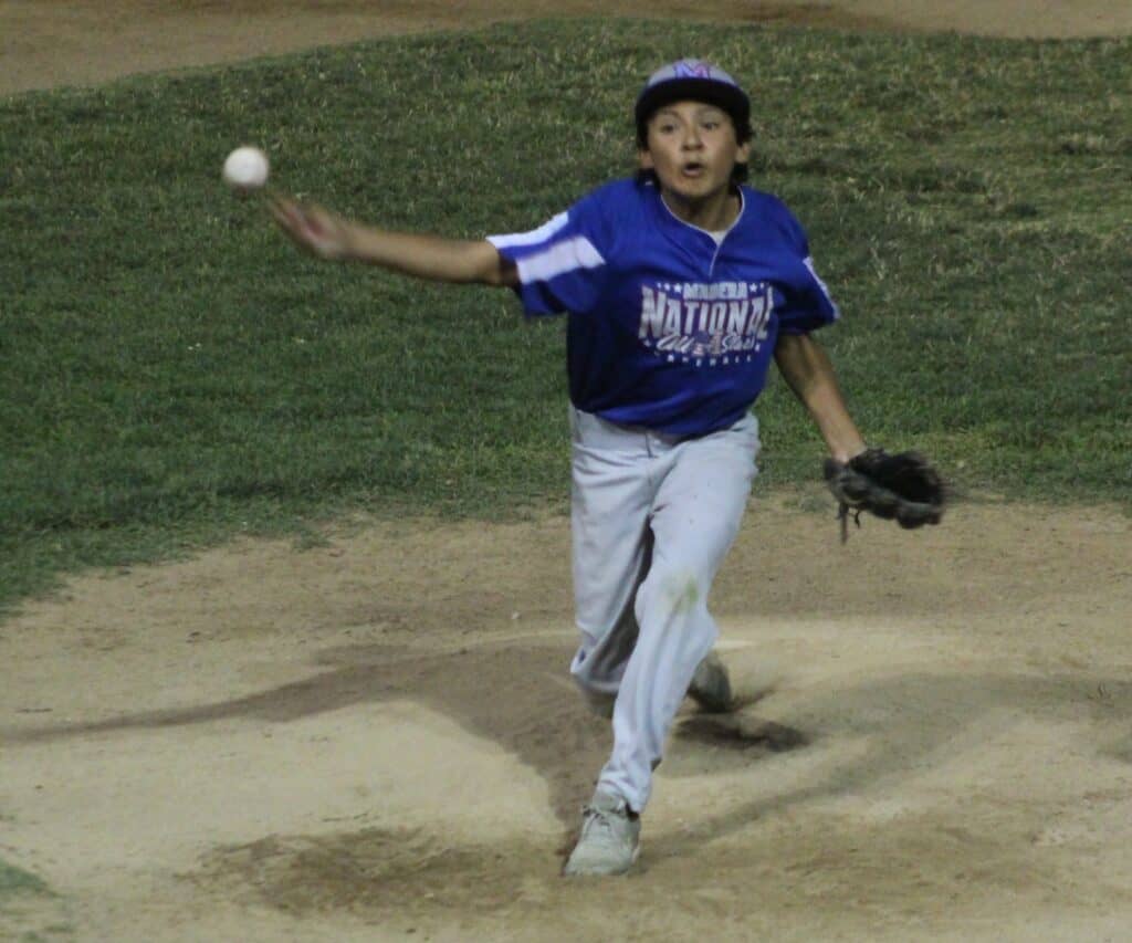 Photo - Madera National’s Solomon Reyes throws a pitch in Friday’s win over Sunnyside. He helped contribute to a combined no-hitter. Reyes picked up the win in two innings of work with four strikeouts. 