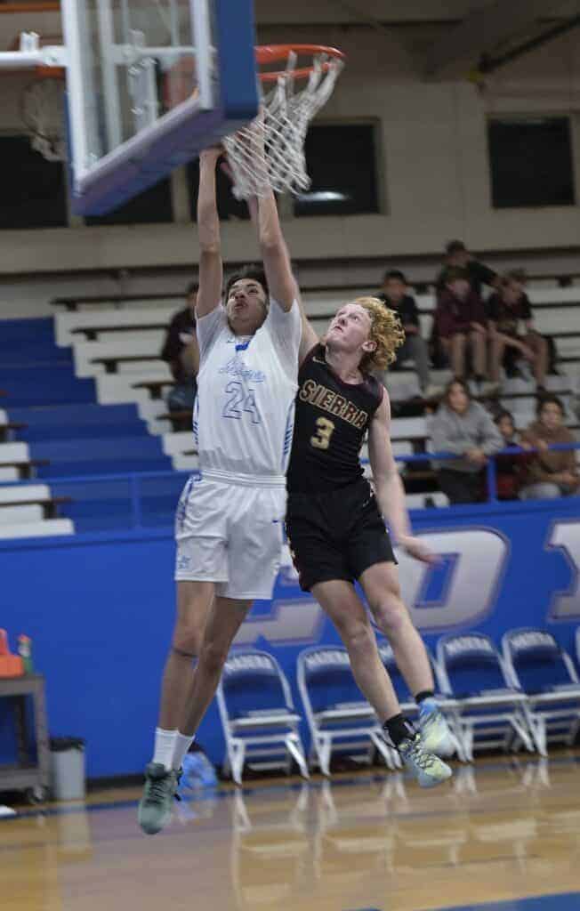 Photo - Madera’s Brooke Houghton flies down the lane for a layup during Tuesday’s loss to Kingsburg. Houghton scored nine points with a team-leading 10 rebounds.