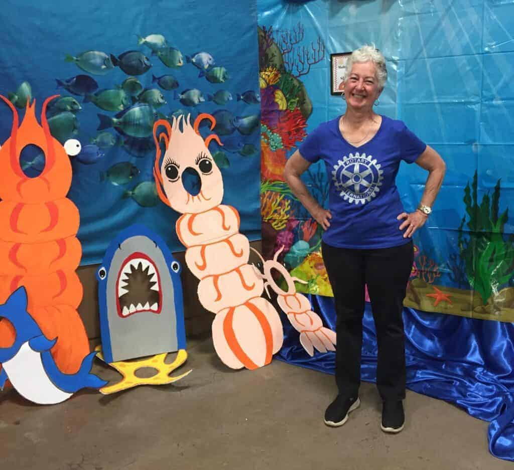 Photo - Madera Sunrise Rotary member Tina Holmquist poses with various photo board props during the 2022 Madera Rotary Shrimp Feed. The Madera Sunrise Rotary will host its annual Shrimp Feed on Saturday at Hatfield Hall on the Madera Fairgrounds.