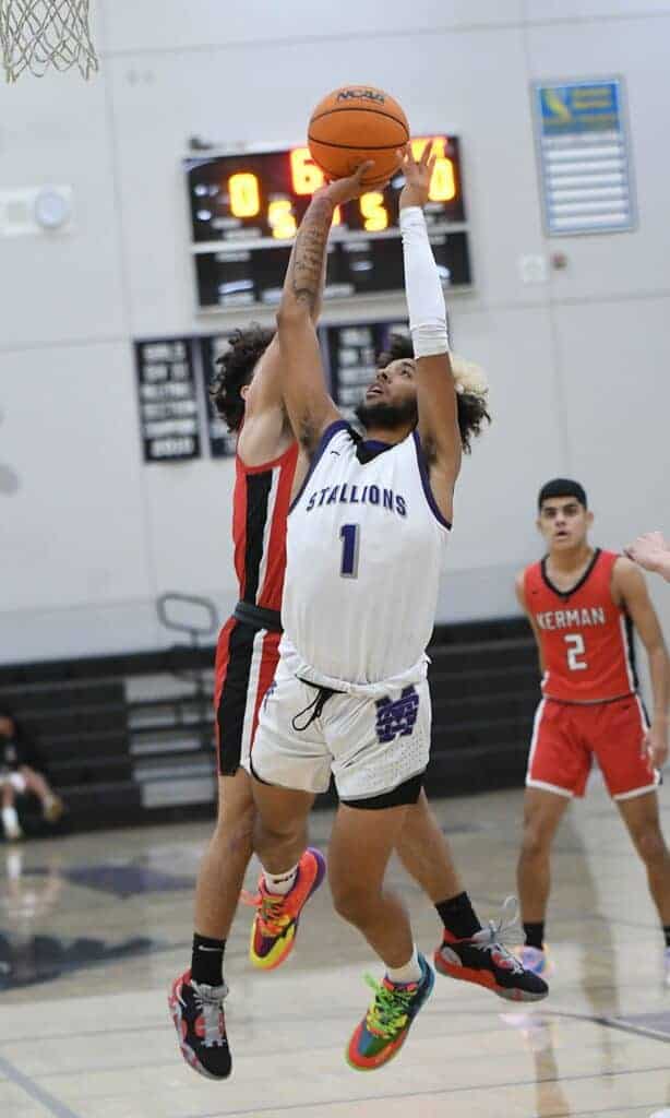 Photo - Madera’s JoJo Pickens pulls up in front of Madera South’s Ahmed Sharhan for a jumper during Wednesday’s rout of the Stallions.