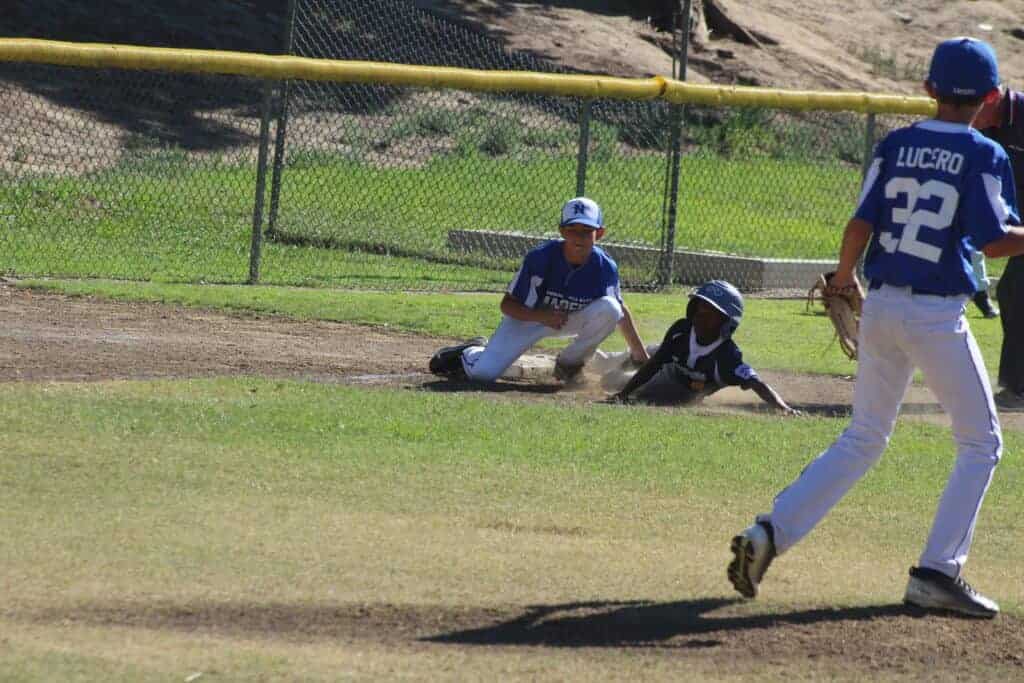 Photo - Madera National third baseman Christian Guerrero makes the tag on an incoming Sunnyside baserunner to complete a double play during Saturday’s victory.