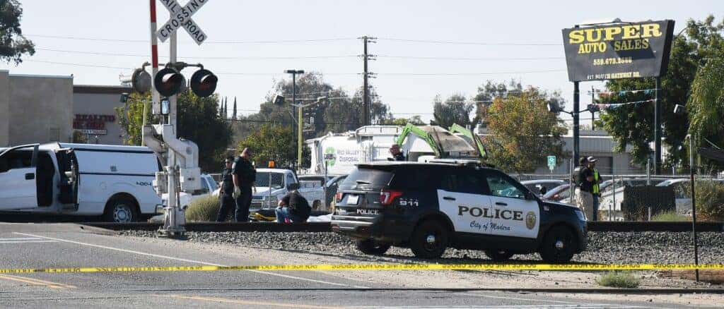 Photo - Crews investigate the scene of a fatality on the railroad tracks near Ninth Street and Gateway Drive.