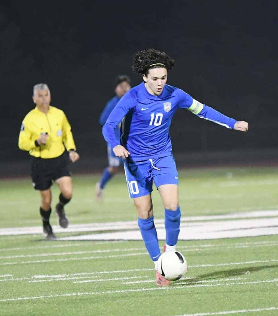 Photo - Madera’s Elias Zuniga works the ball up the field during Friday’s loss to the Sanger Apaches.
